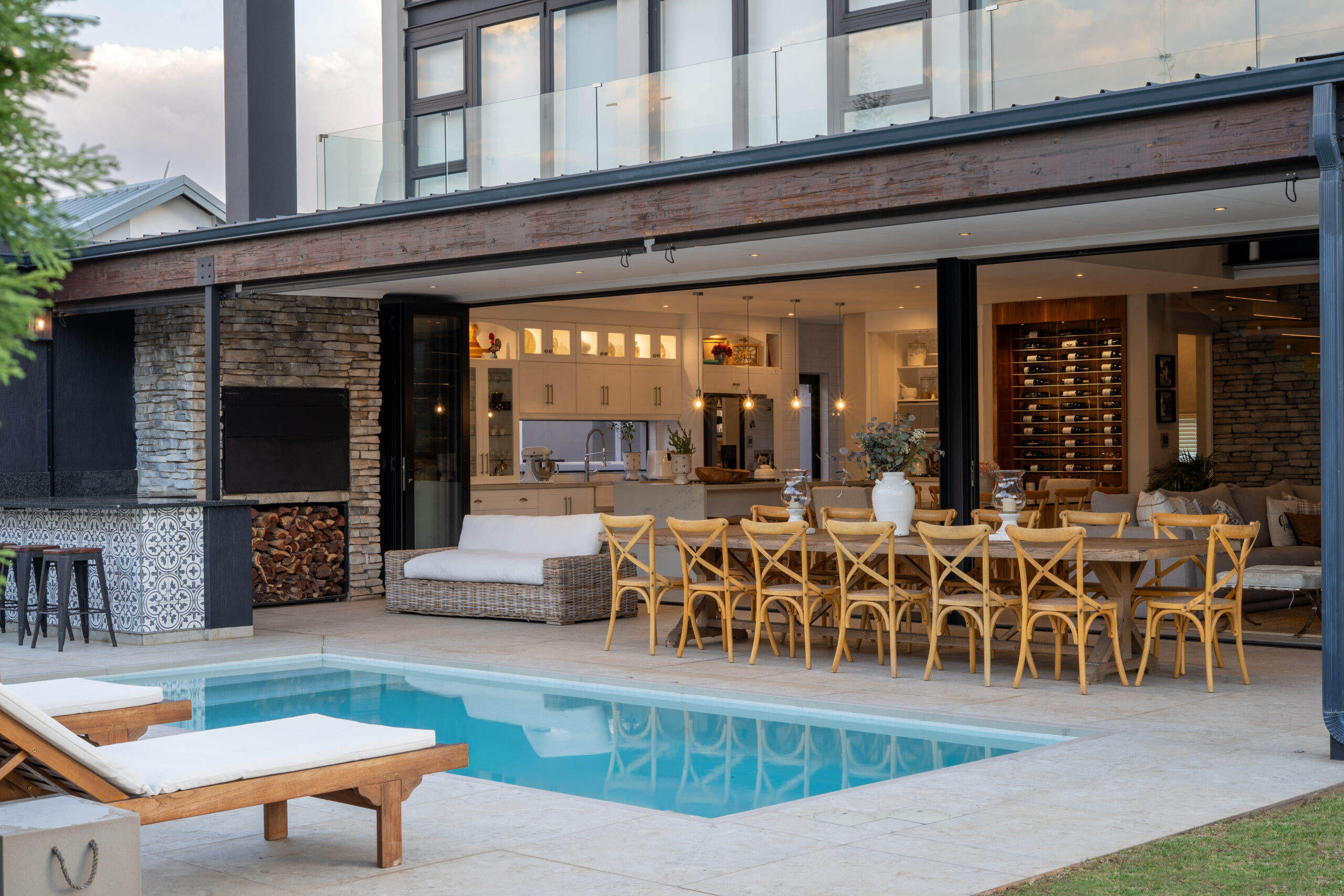 Real Estate Photography & Videography Gauteng - indoor-outdoor kitchen, dining area and pool captured for a property listing
